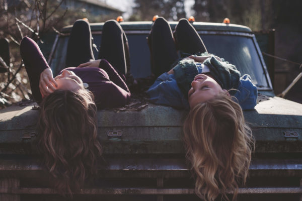 teen girls lying on their backs on a truck