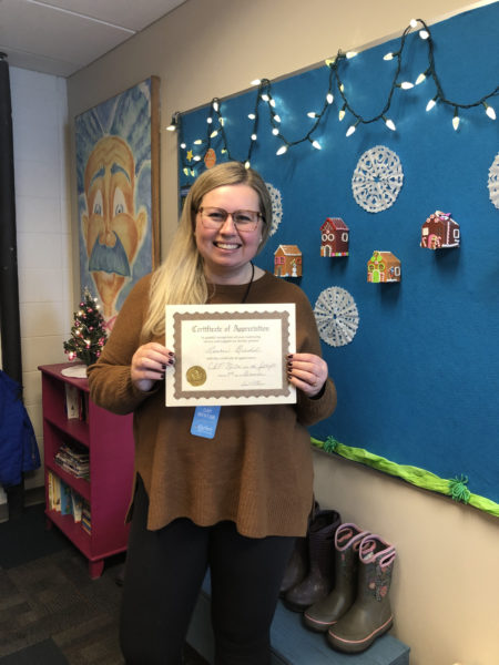 Lauren Brendel, January CAP Mentor in the Spotlight, smiles and holds her certificate.