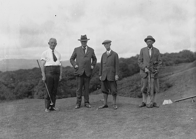Four_gentlemen_golfers_on_the_tee_of_a_golf_course_(5014828806)